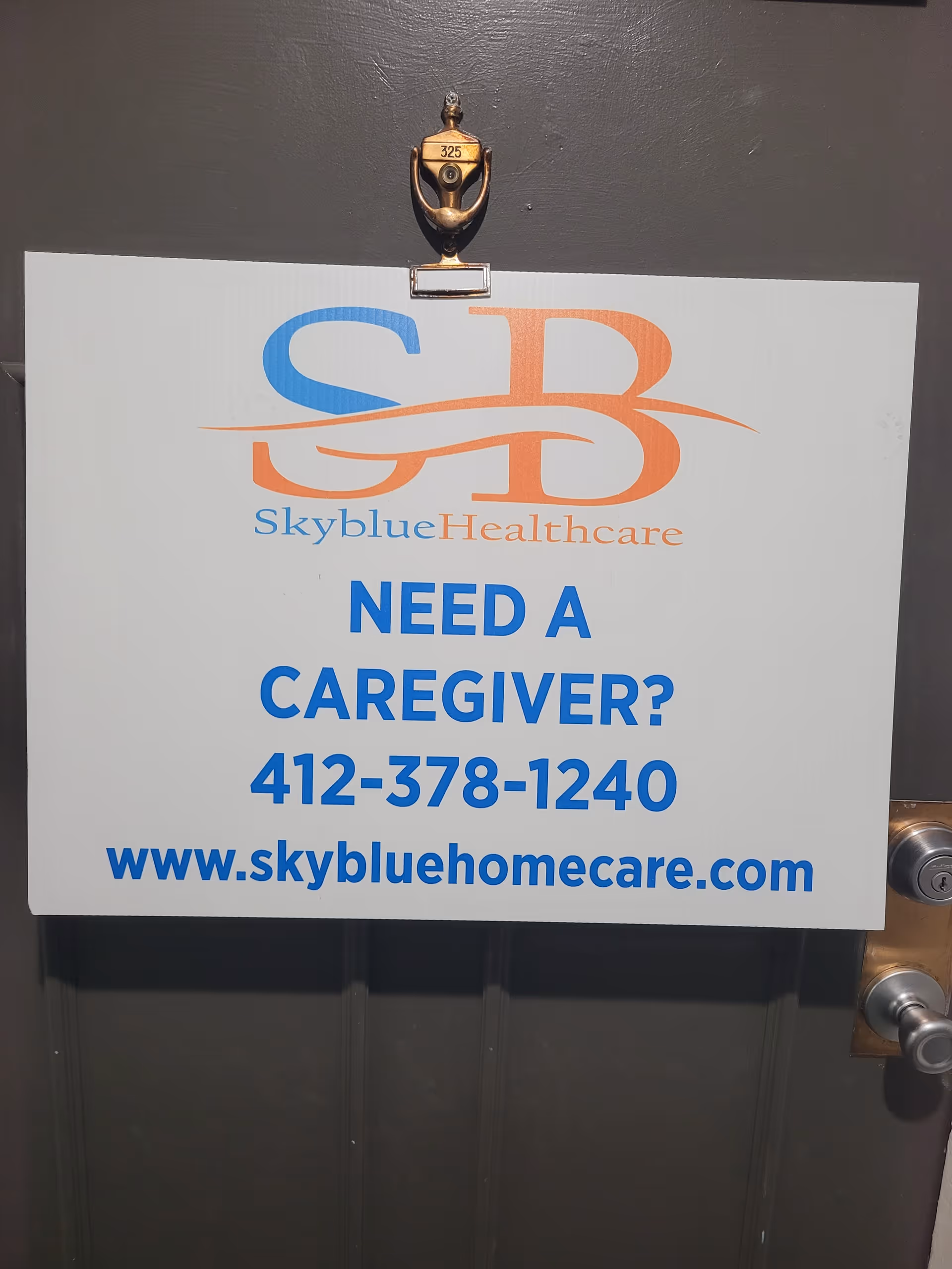 Door with a Skyblue Healthcare sign advertising caregiver services and contact details.