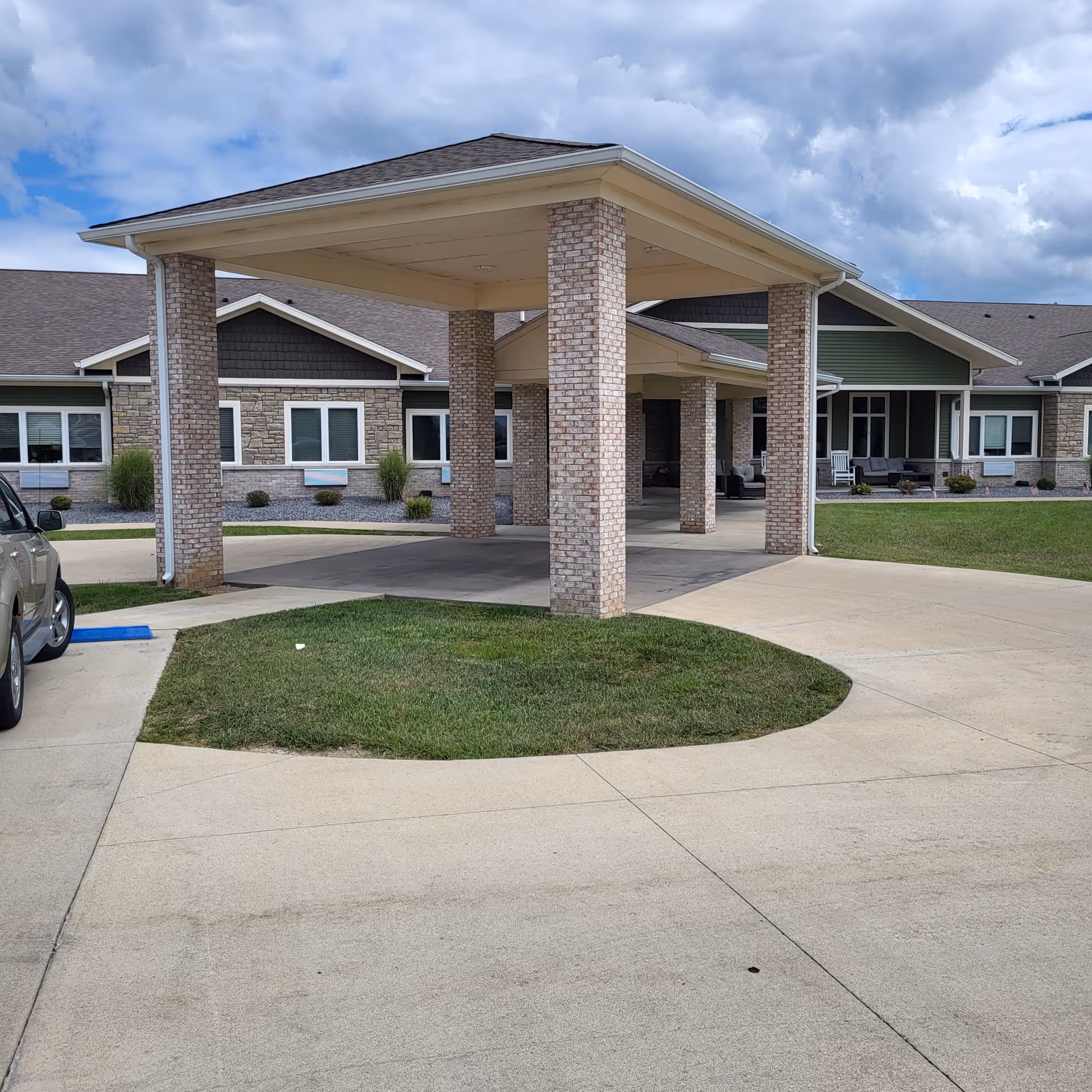 Covered brick entrance with brick columns at Autumn Trace Senior Communities.