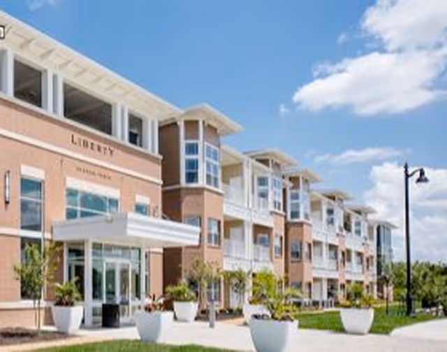 Exterior view of Liberty at Shoal Creek building with brick facade and landscaped front entrance.