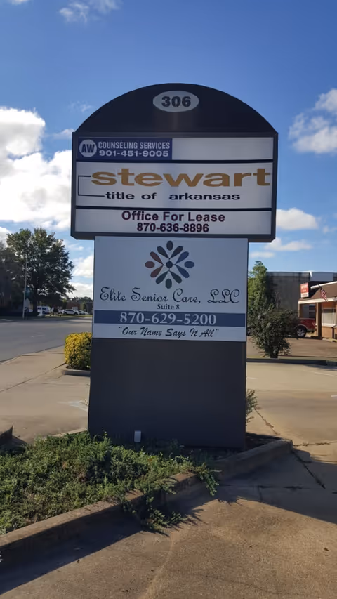 Tall outdoor sign pedestal displaying Elite Senior Care LLC among other business signs.