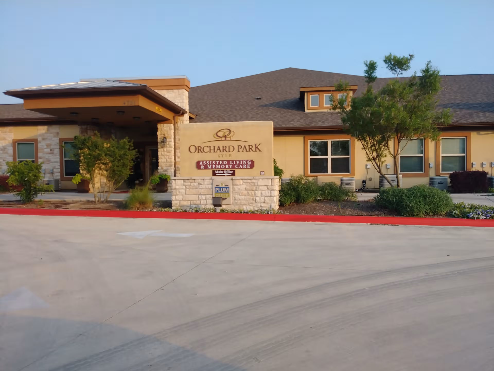Exterior view of Orchard Park Kyle Assisted Living & Memory Care building entrance.