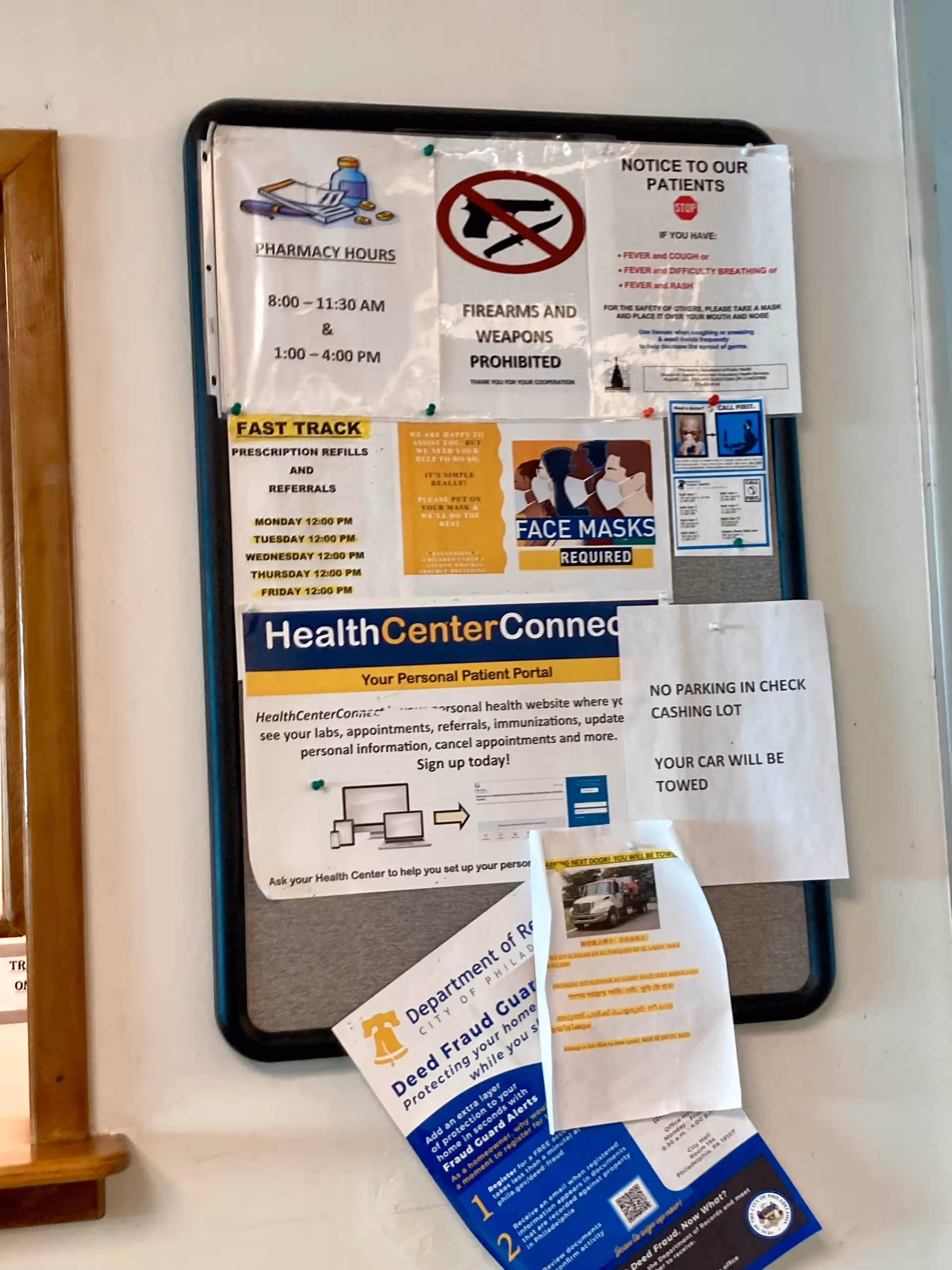 Bulletin board with notices and posters mounted on a wall.