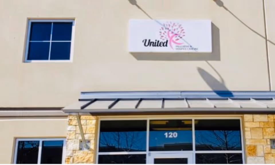 Exterior view of United Palliative & Hospice Care facility with entrance and sign.