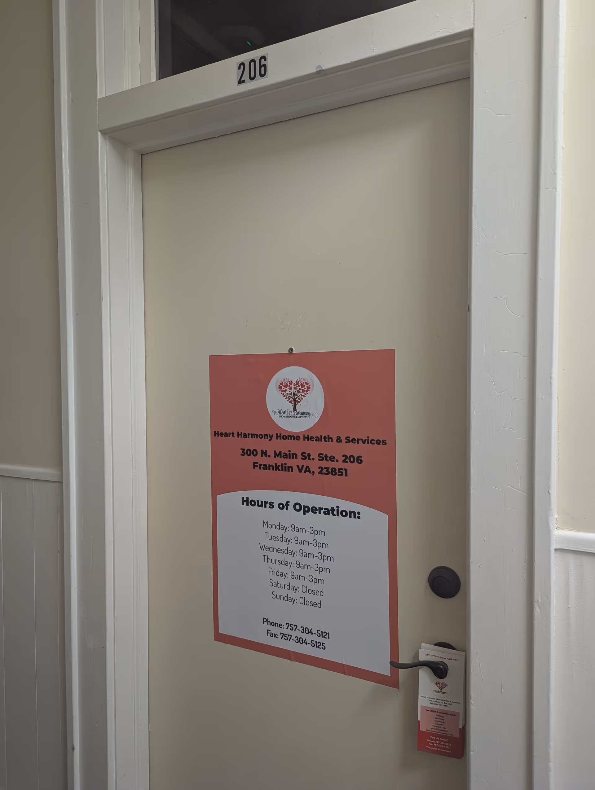 Interior door labeled 206 with a Heart Harmony Home Health & Services sign and hours.