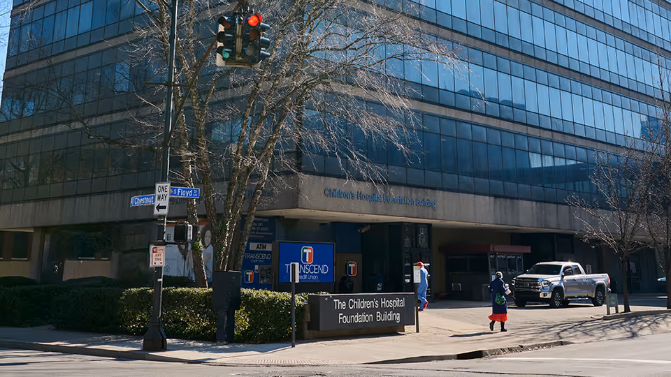 Exterior view of a glass-front building with a sign Children's Hospital Foundation Building.