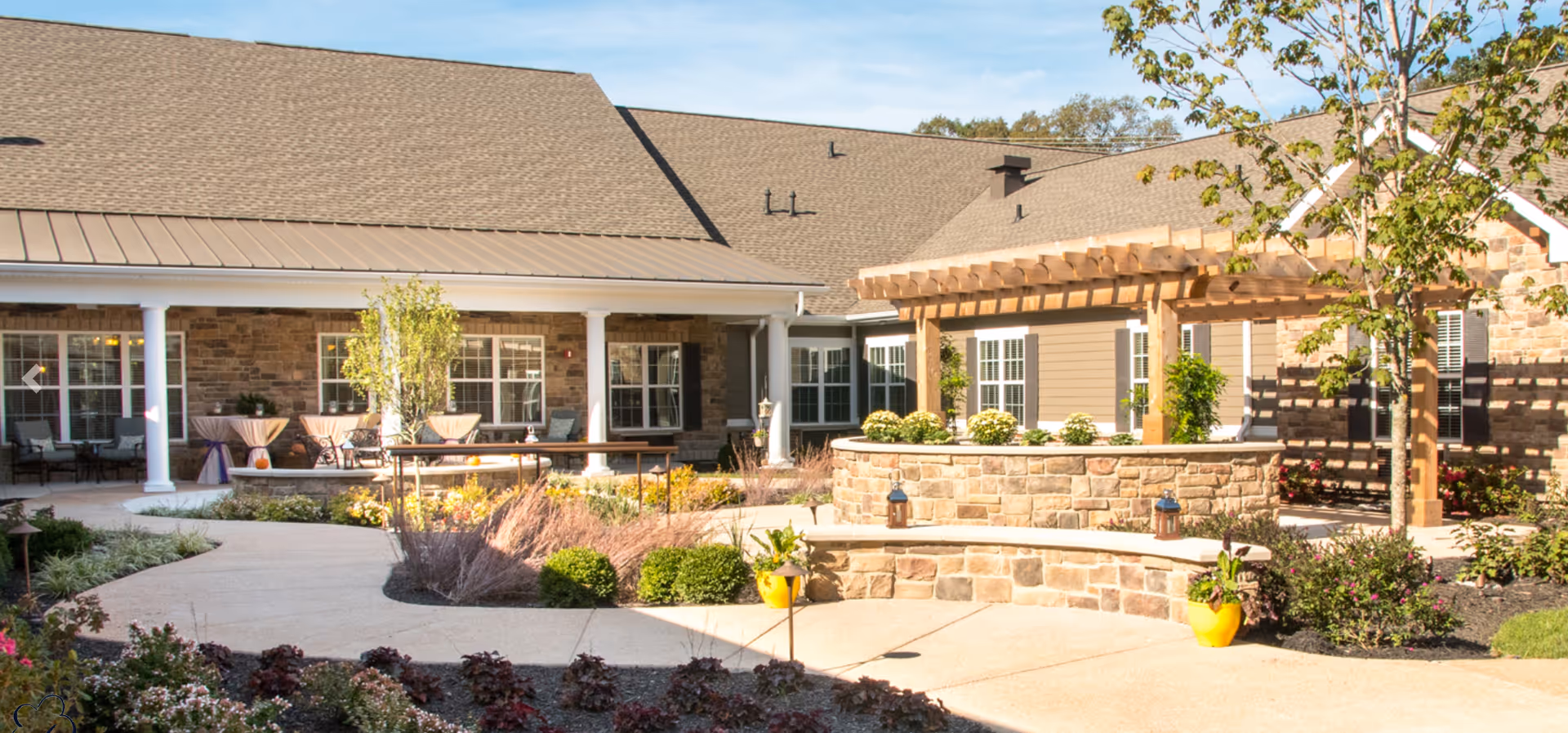 Bickford of Chesterfield exterior with covered patio seating and landscaped courtyard.