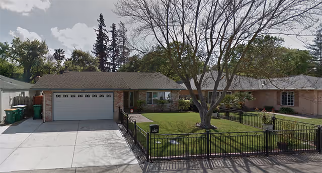 Lincoln Manor senior living facility, a single-story building with a fenced front yard and driveway.