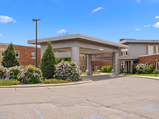 Exterior view of Sanford Health Neilson Place entrance with covered drop-off and landscaping.