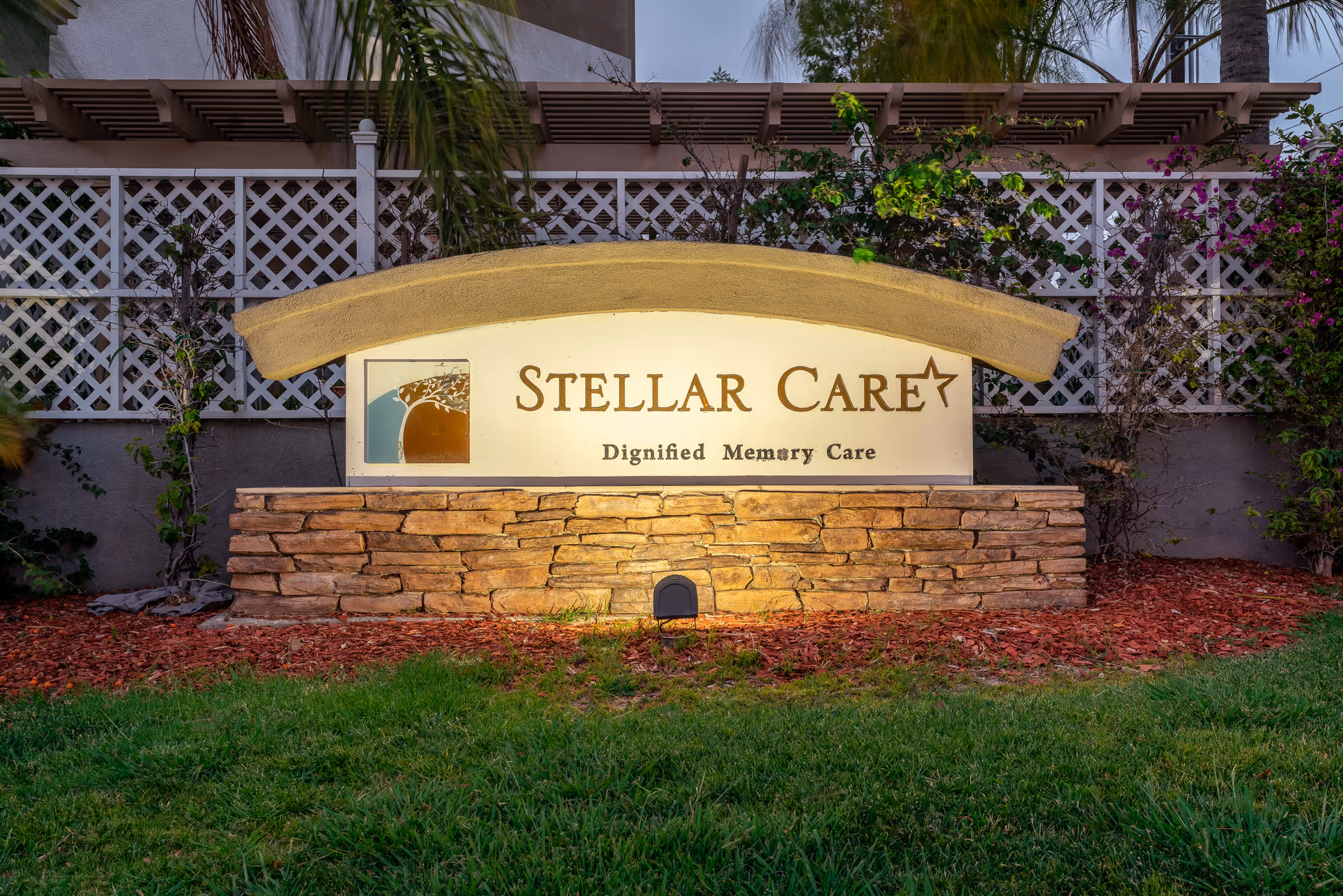 Exterior sign for Stellar Care mounted on a stone base with manicured landscaping.