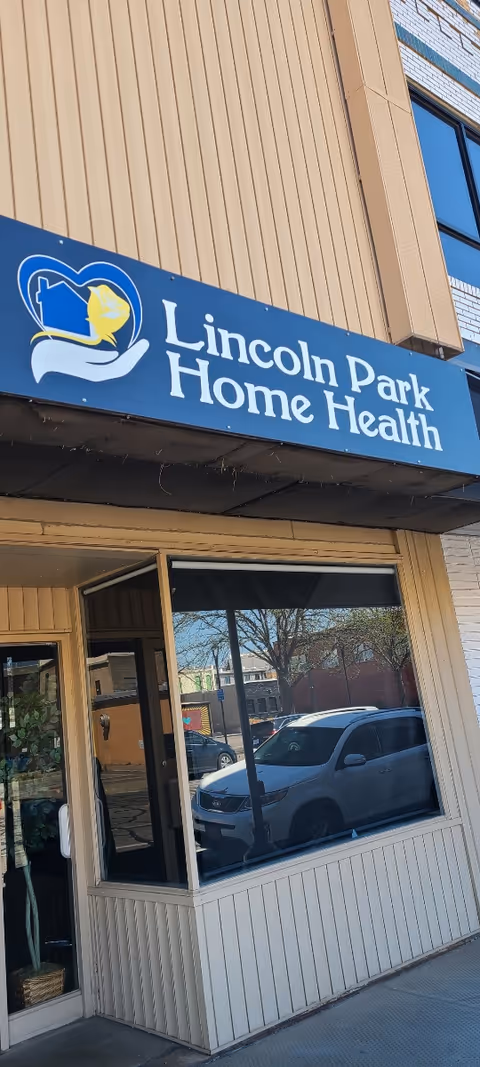 Exterior view of Lincoln Park Home Health storefront with blue sign and large window display.