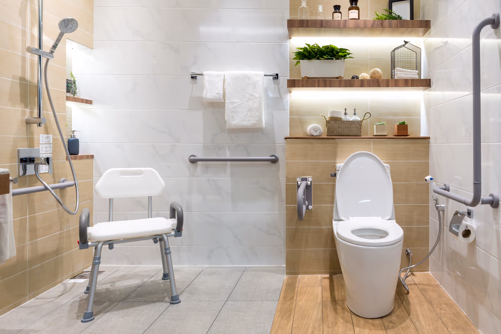 Accessible bathroom with a shower chair, toilet, grab bars, and wooden shelves.