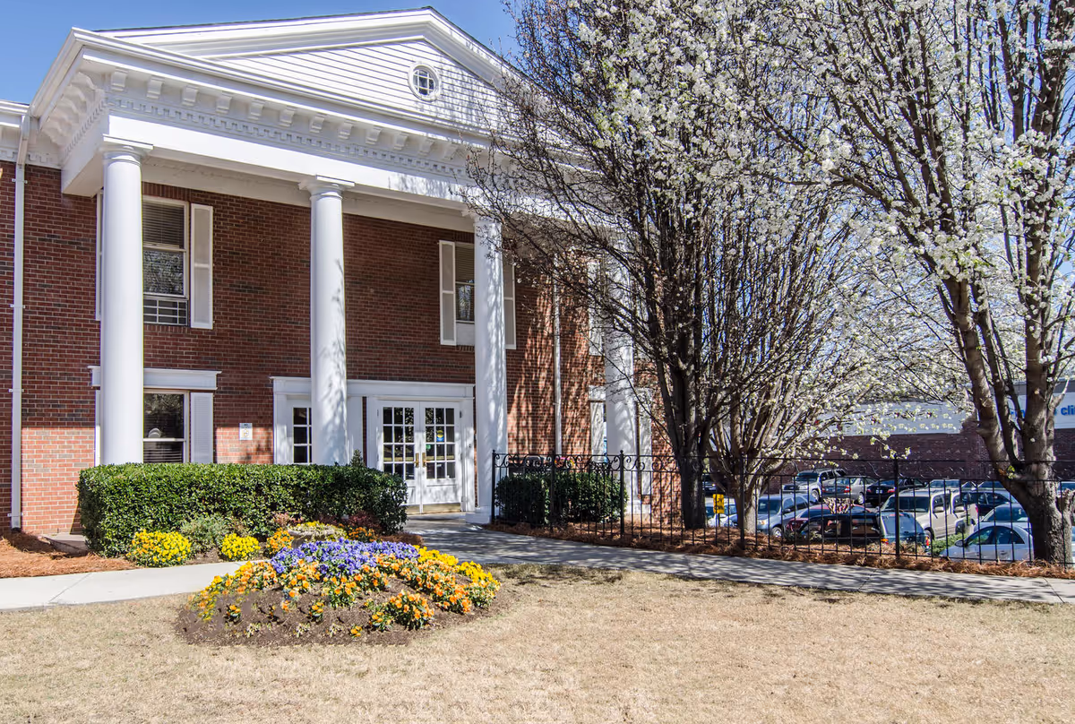 Decatur Center for Nursing and Healing exterior with white columns, entrance, and blooming trees.