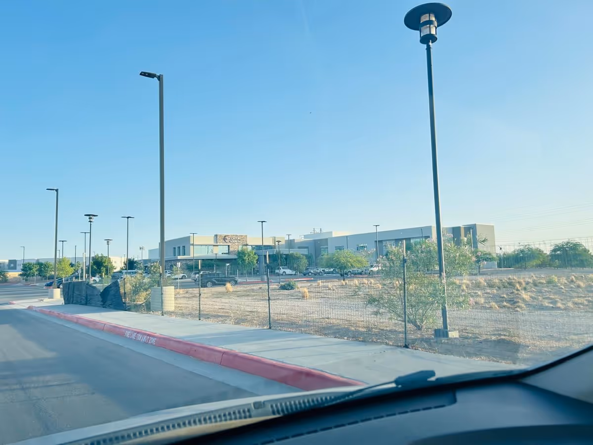 Exterior view of Center at Zaragoza with a parking lot and streetlights.
