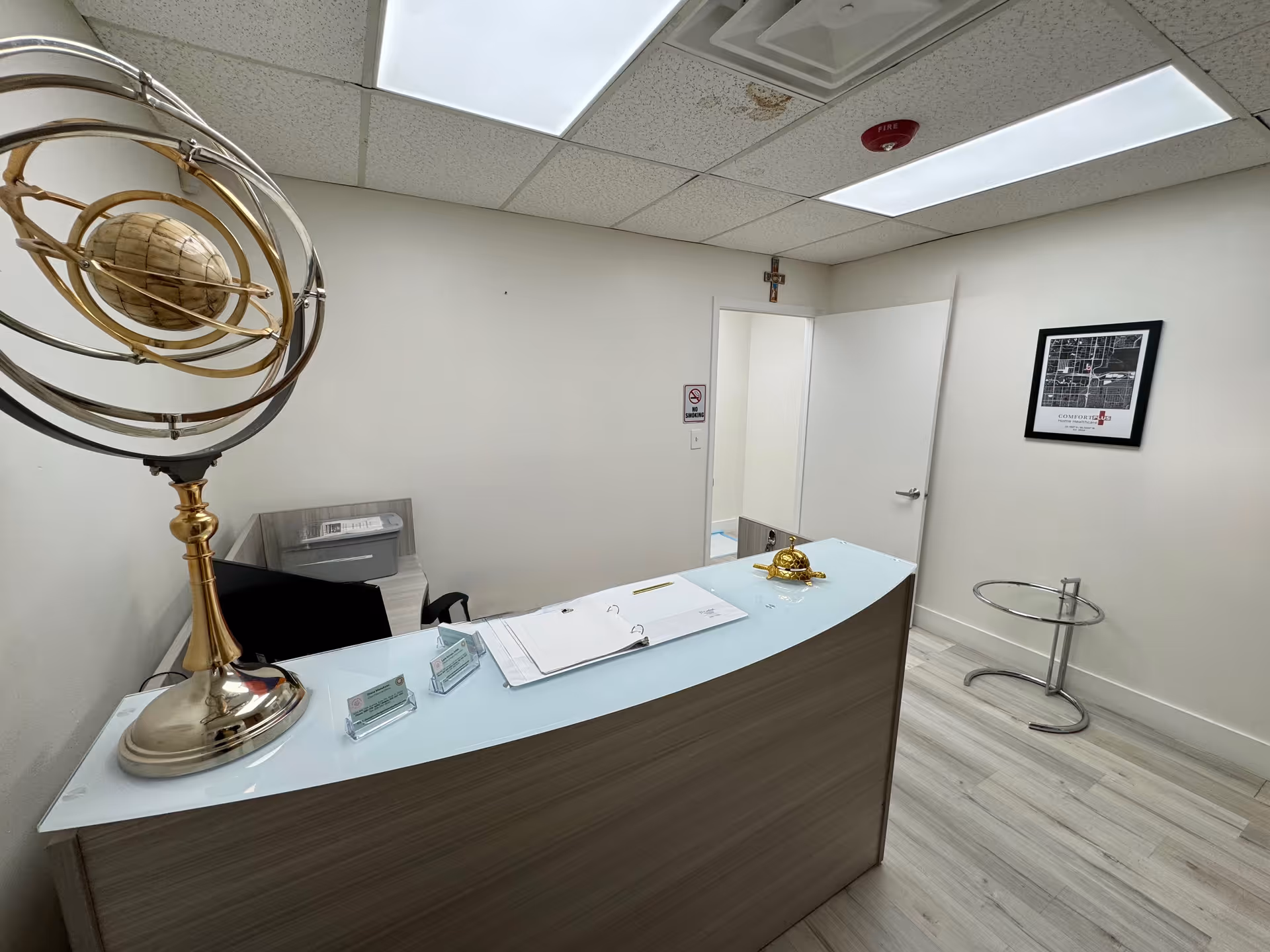 Reception desk with documents and office decor inside a senior living facility.