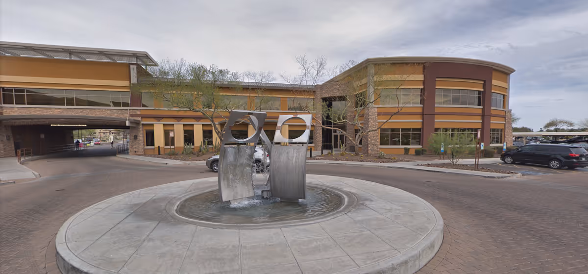 Exterior view of Hart2Heart facility with a circular fountain at the entrance.