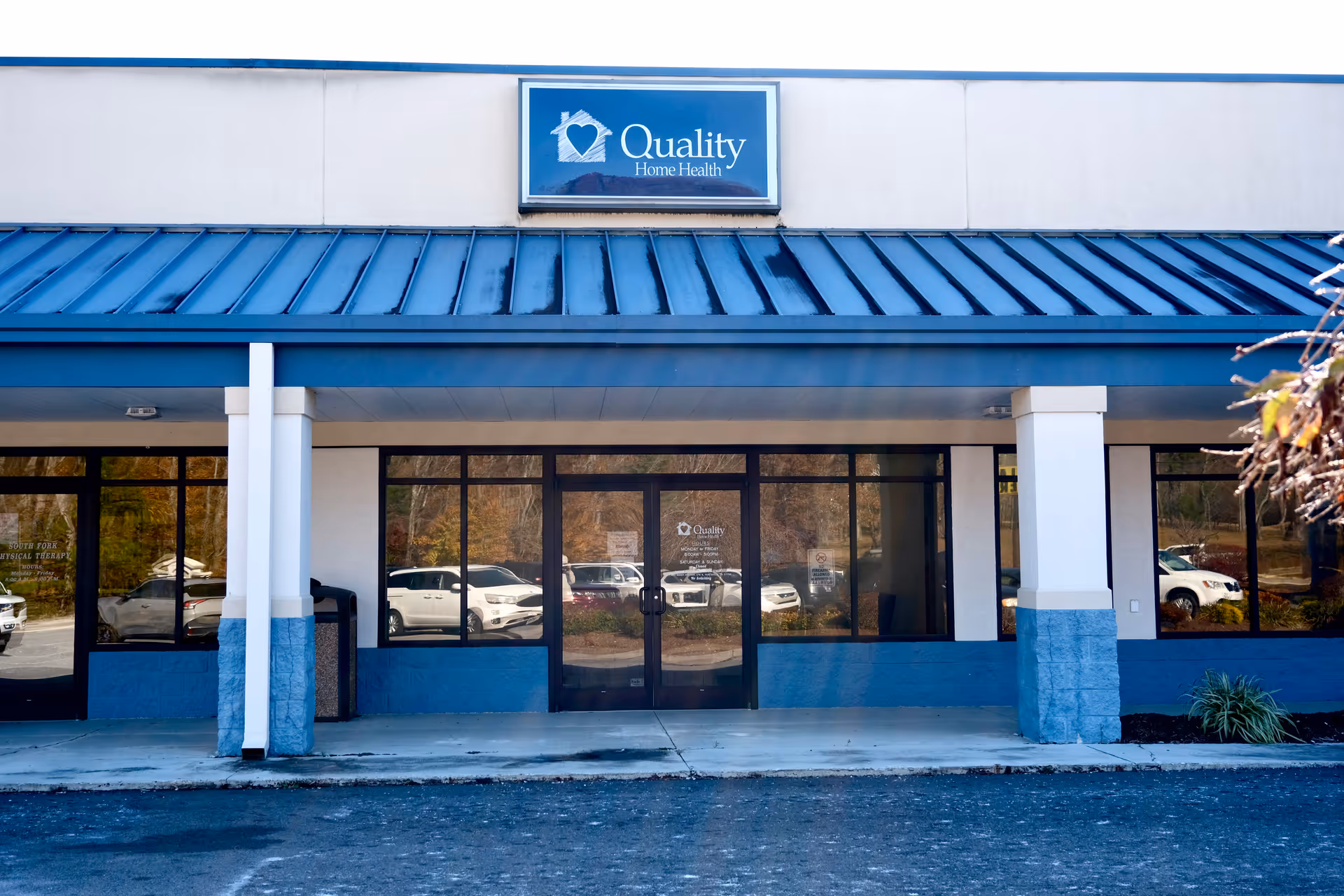 Front view of Quality Home Health facility with blue awning and glass doors.