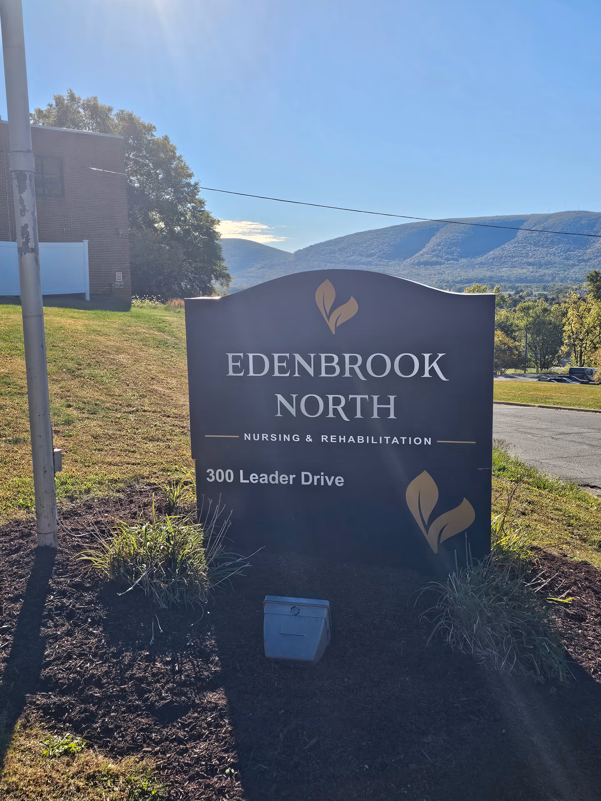 Outdoor Edenbrook North sign with landscape and hills in background.