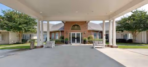 Front entrance of a Brookdale Mandeville senior living community with a covered drop-off.