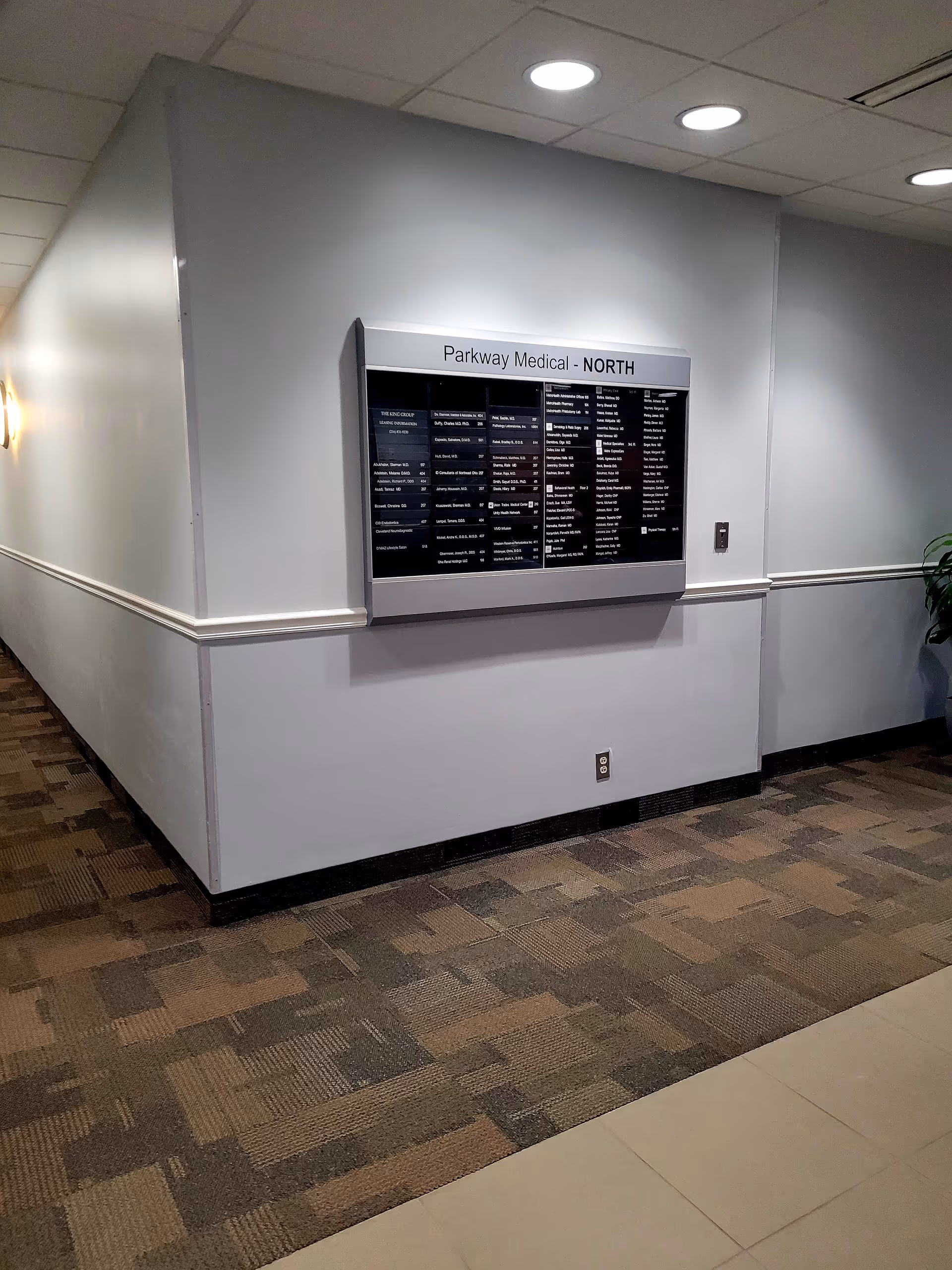 Interior hospital corridor featuring a wall-mounted directory sign labeled Parkway Medical North