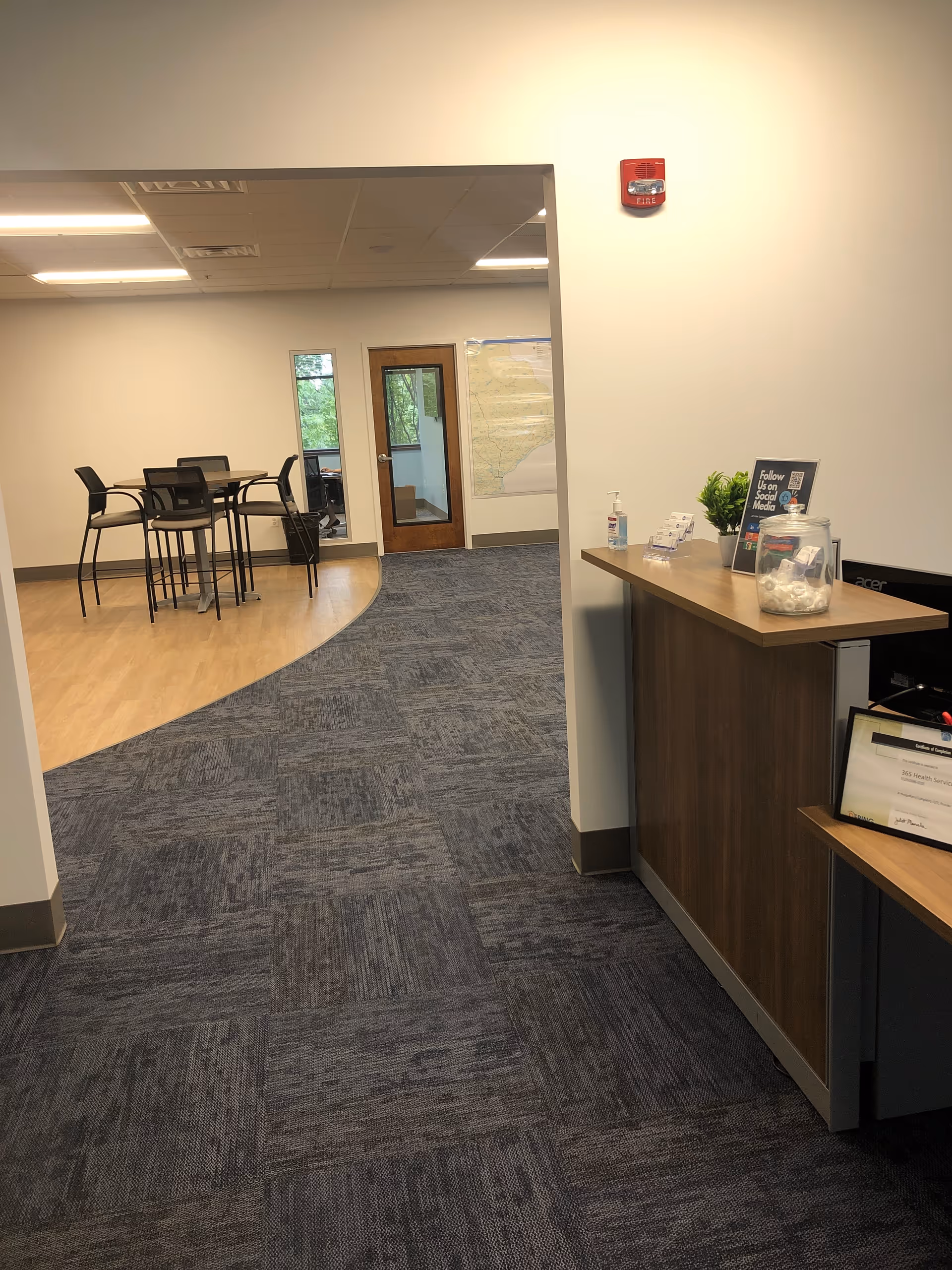 Interior lobby with a reception desk to the right and a seating area.