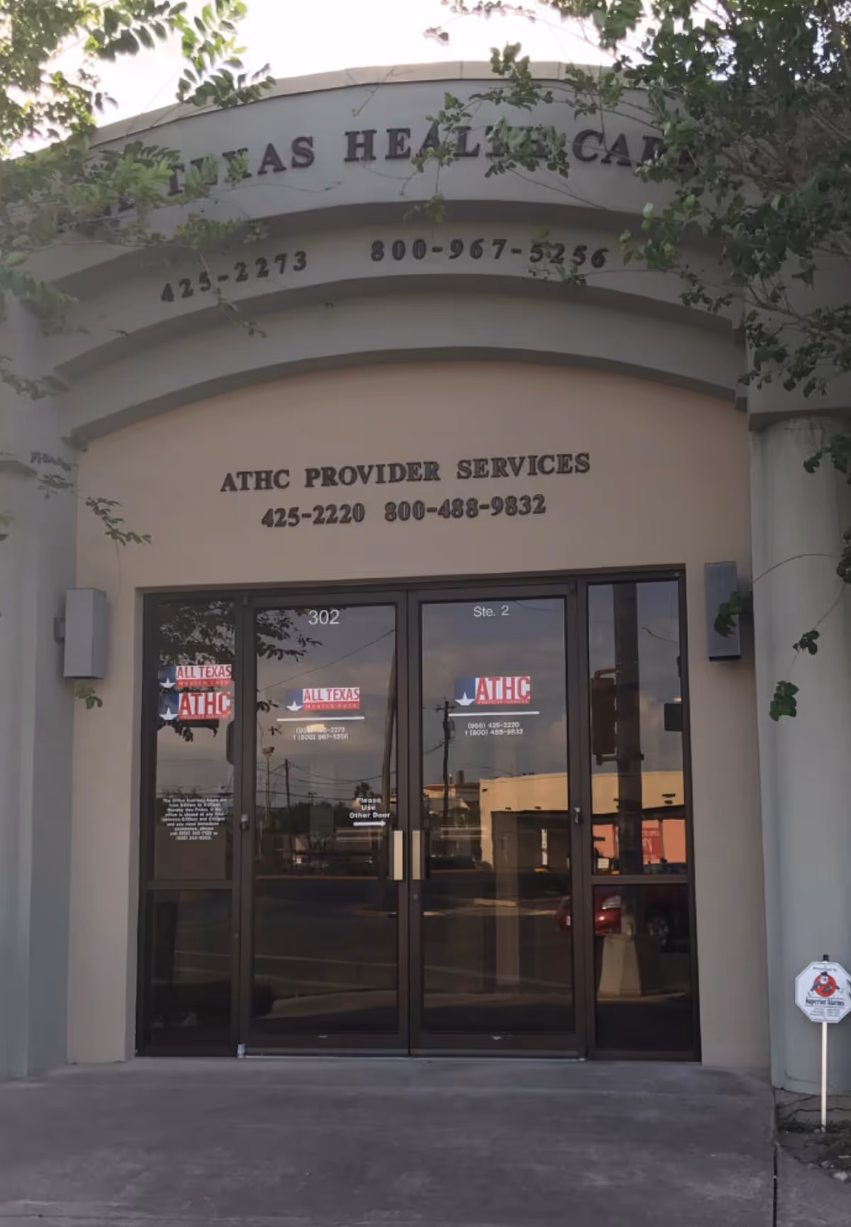 Front view of All Texas Health Care entrance with glass doors and signage.