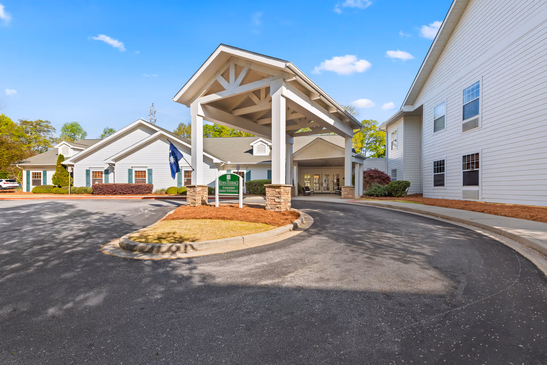 Exterior view of Eden Terrace of Spartanburg entrance with circular driveway and covered portico.