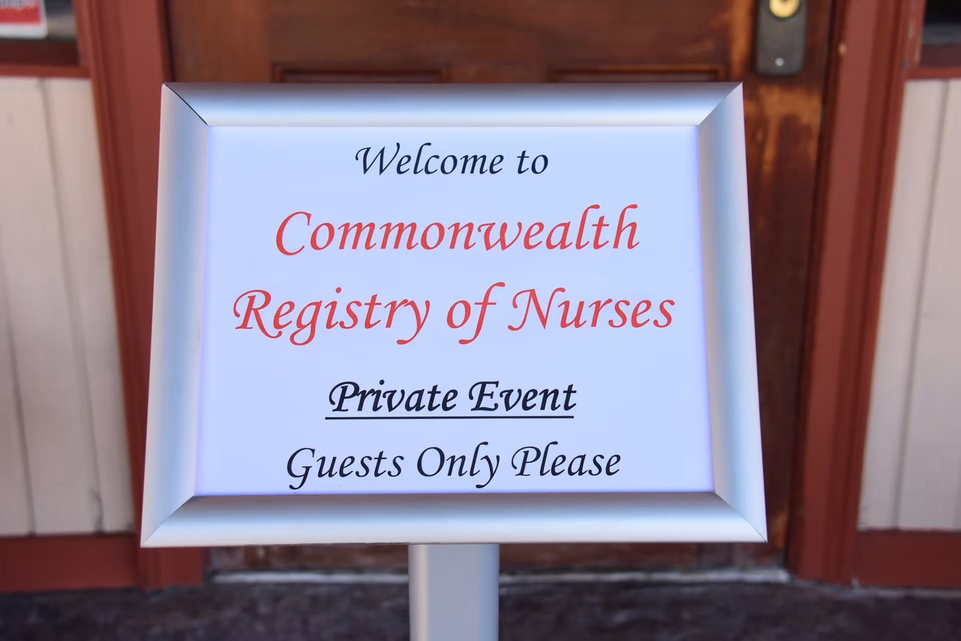 A framed sign reads Welcome to Commonwealth Registry of Nurses near a doorway.