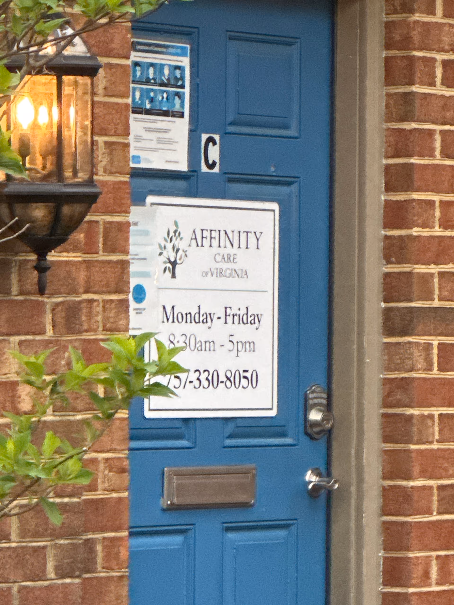 Blue door with Affinity Care of Virginia sign on brick exterior.