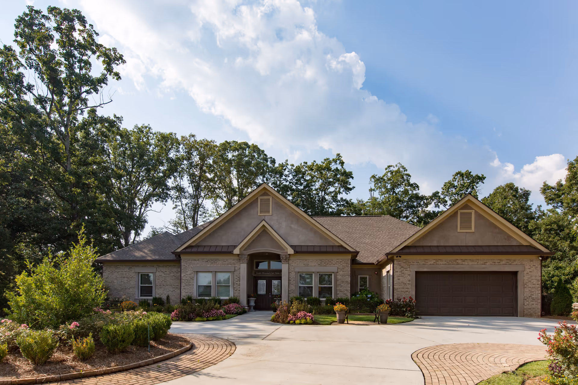 Single-story senior living facility with brick facade, driveway, and landscaped entrance.