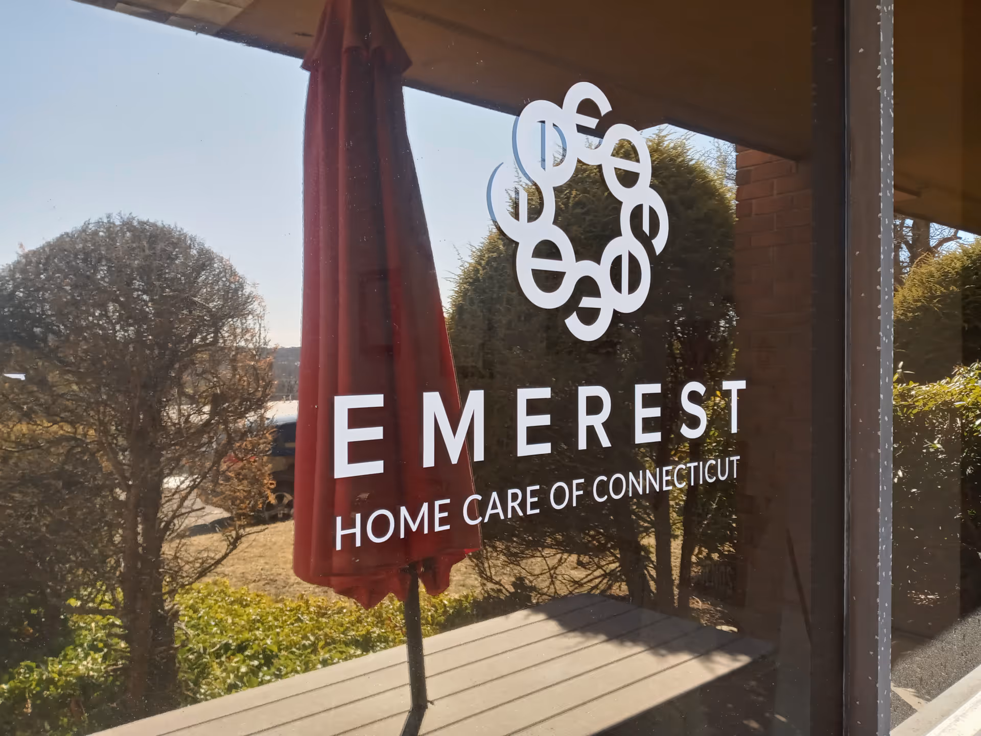 Window sign for EMEREST Home Care of Connecticut on building front