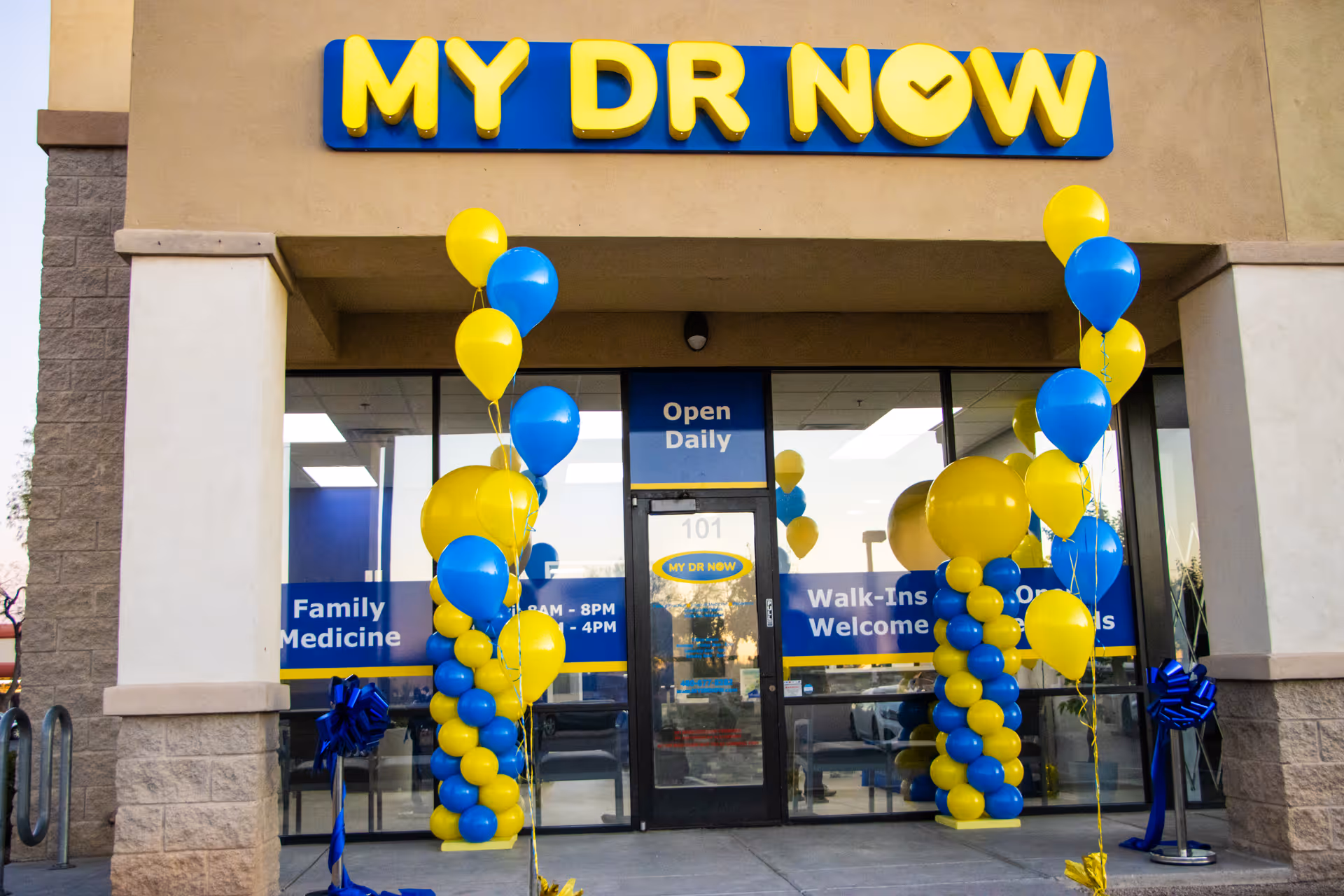 Front entrance of MY DR NOW clinic decorated with yellow and blue balloons.