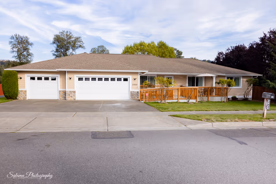 Front exterior of Anointed & Tender Care Adult Family Home 2 with a three-car garage.