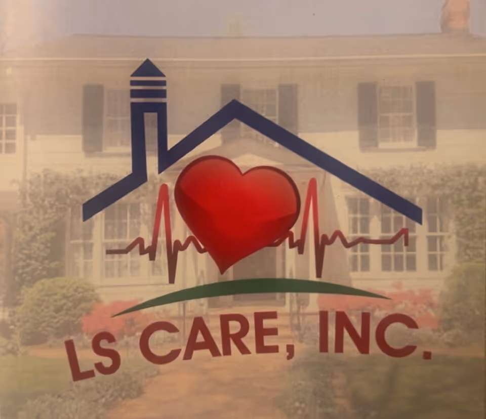 Glass window sign showing a house roof logo with heart and LS CARE, INC, building behind.