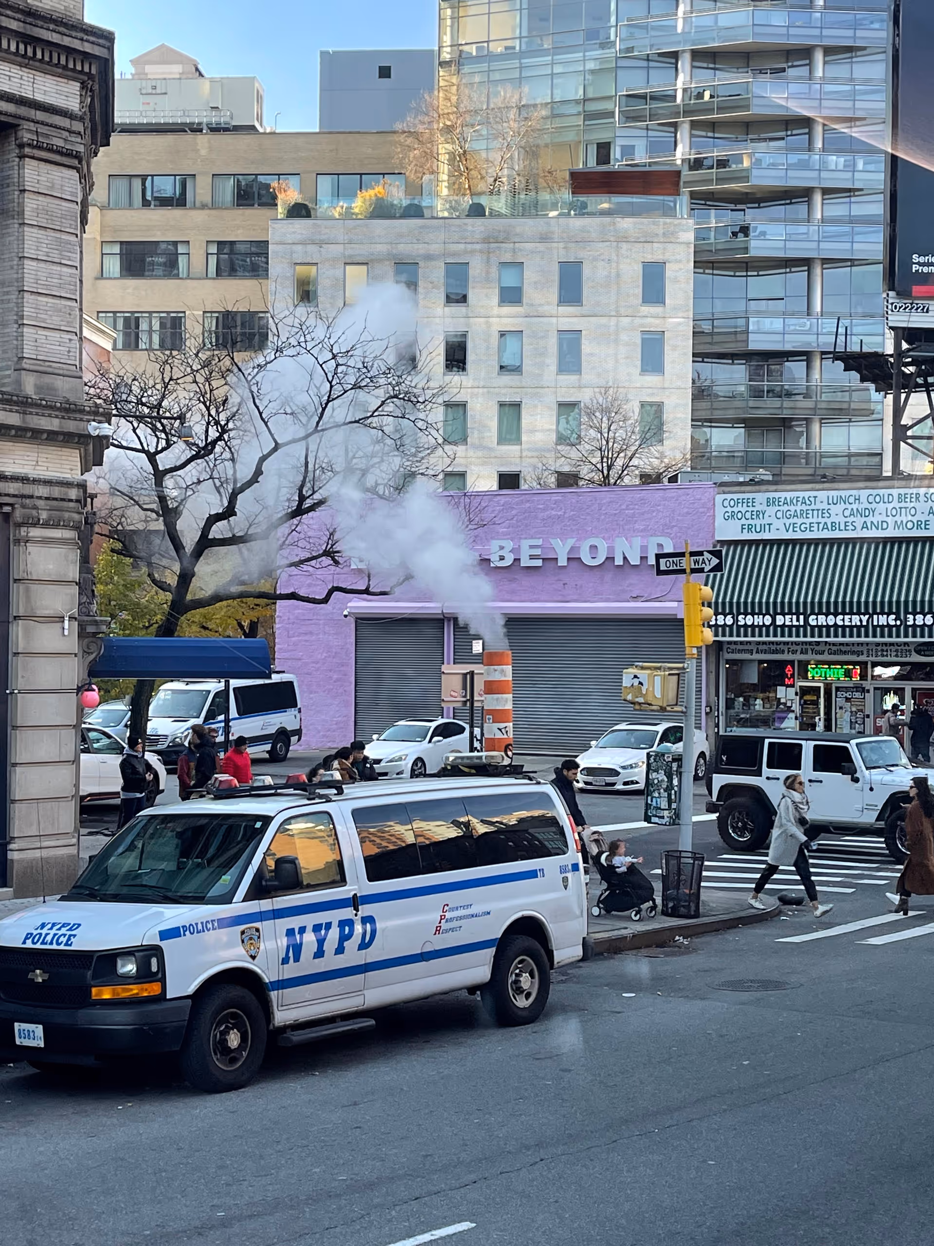 NYC street scene with a white NYPD police van, pedestrians, smoke, and a purple storefront.