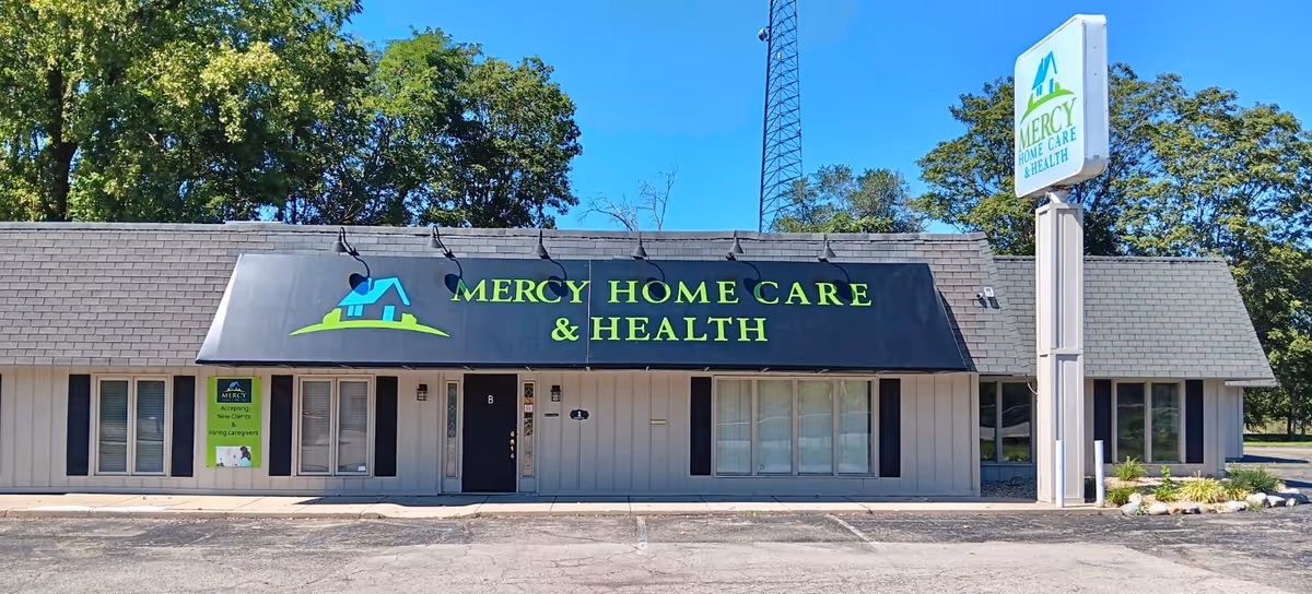 Exterior view of Mercy Home Care & Health building with large sign and storefront windows