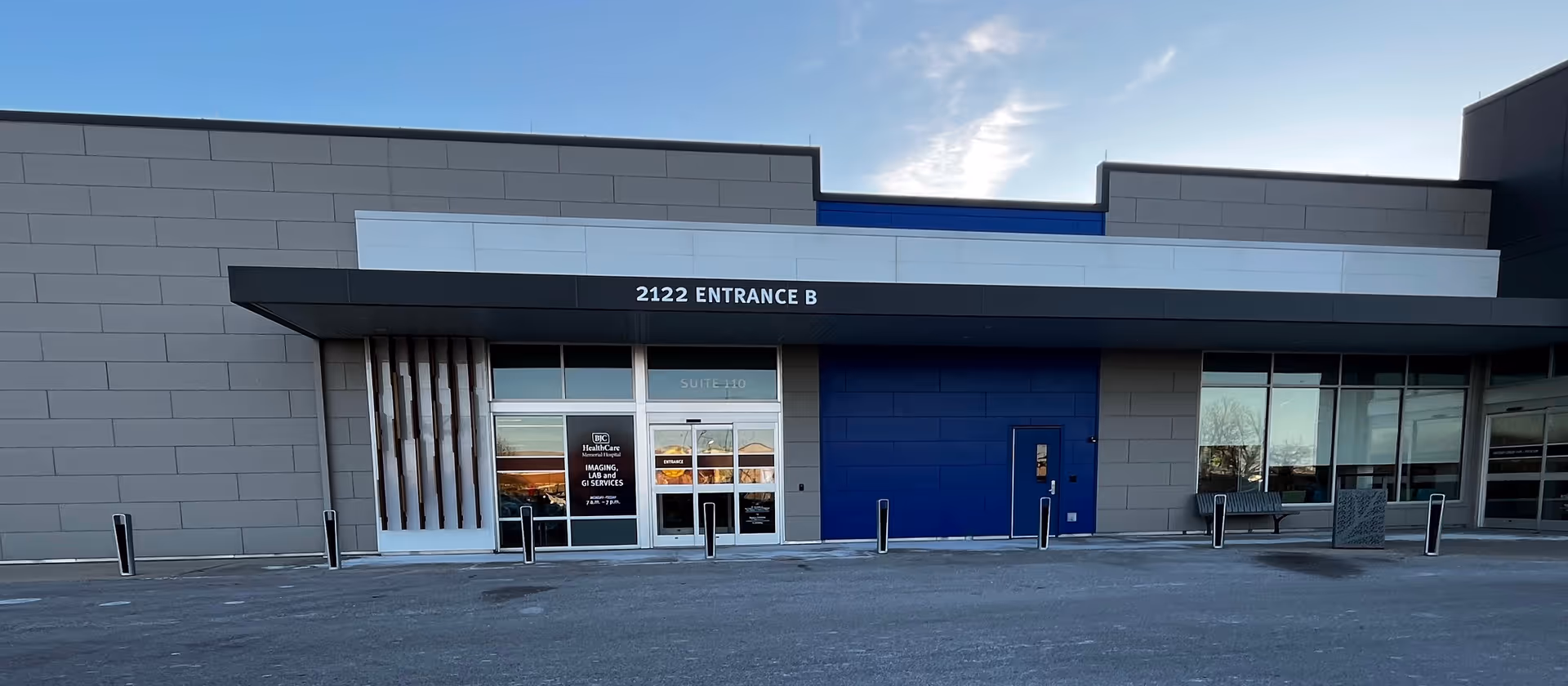 Exterior view of a modern medical center entrance with blue paneling.
