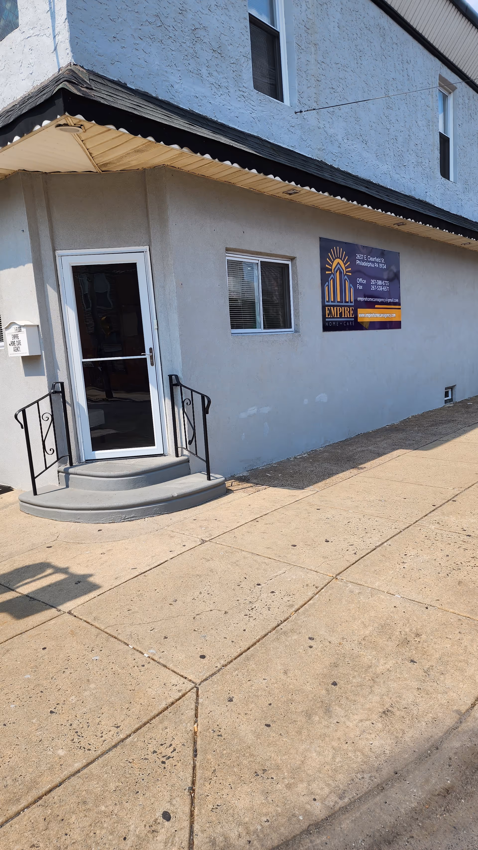 Exterior view of a building entrance with a sign for Empire Homecare Agency LLC.