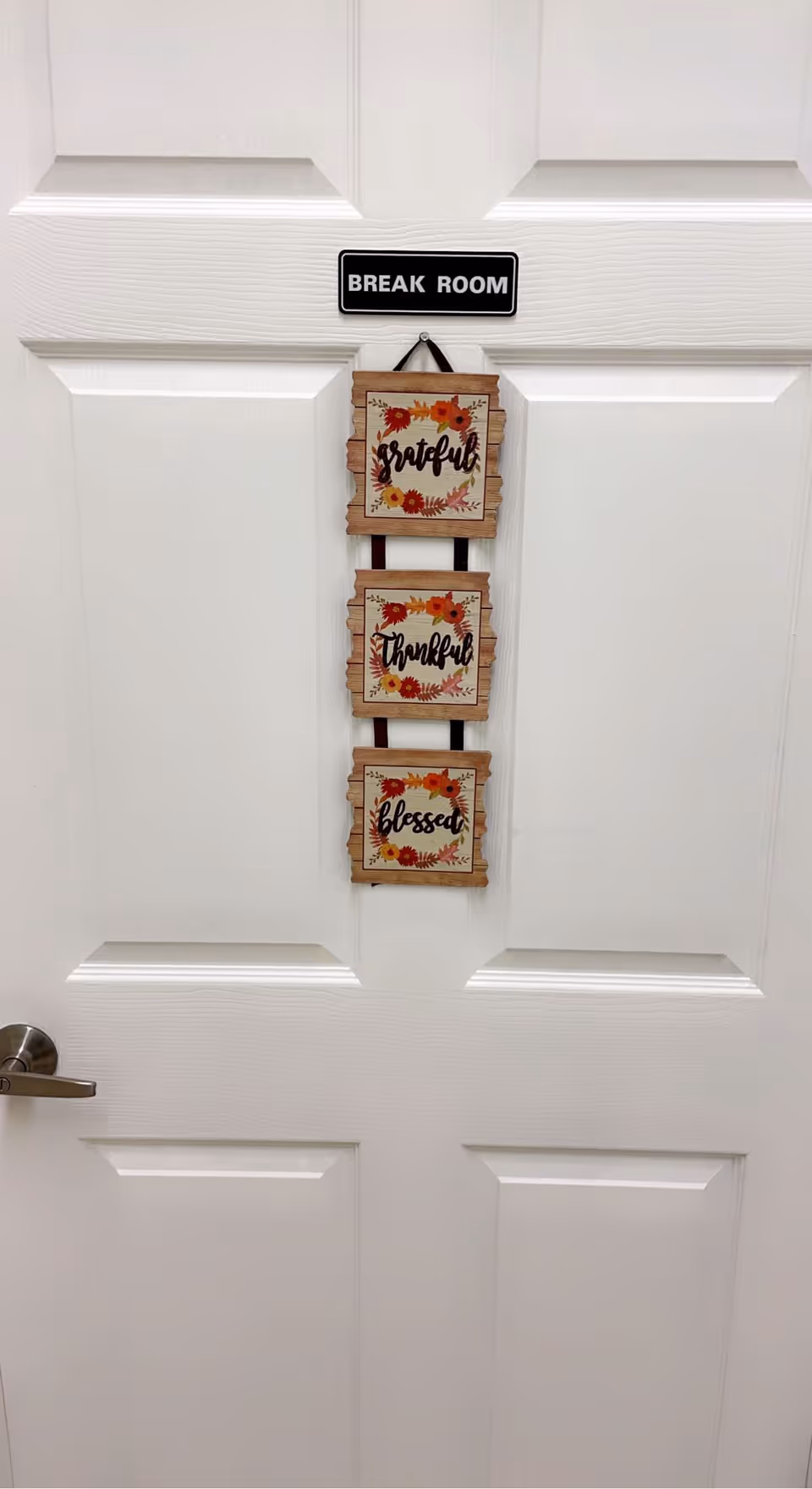White interior door with Break Room sign and three hanging grateful, thankful, blessed plaques.