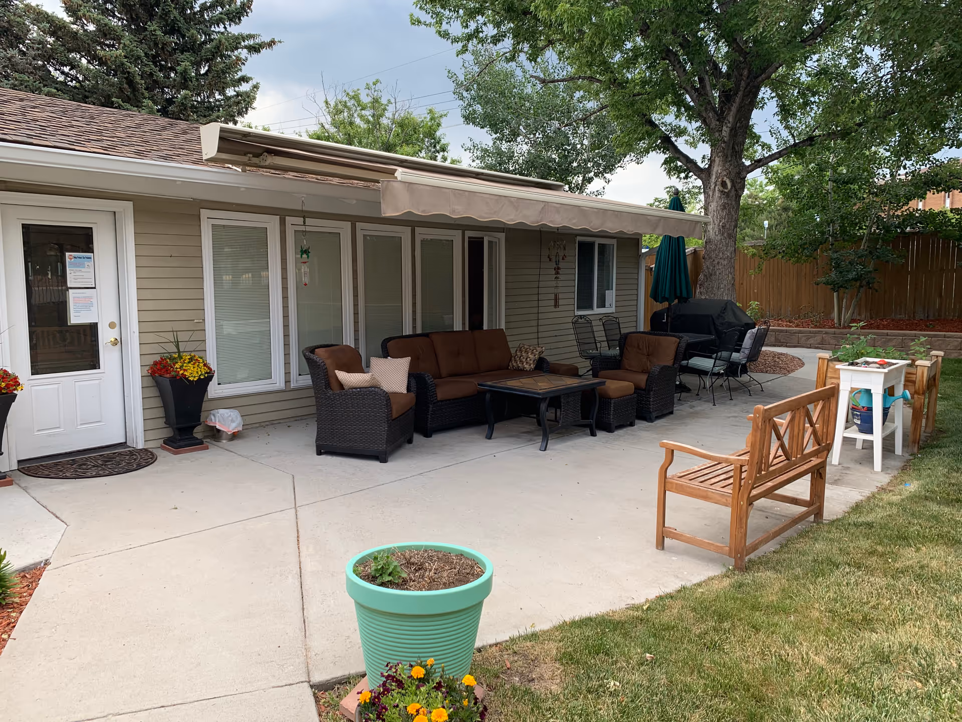 Back patio of Serenity House Assisted Living with outdoor seating and plants.