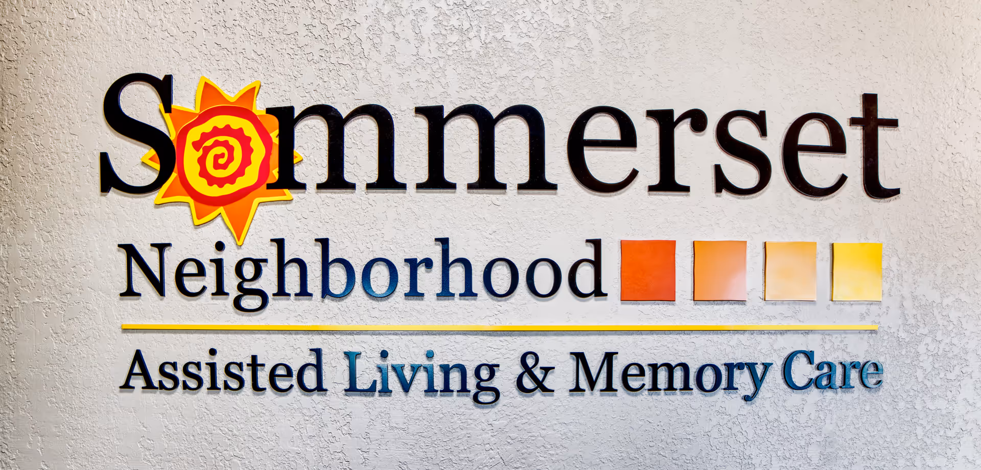 Exterior wall sign reads Somerset Neighborhood Assisted Living & Memory Care.
