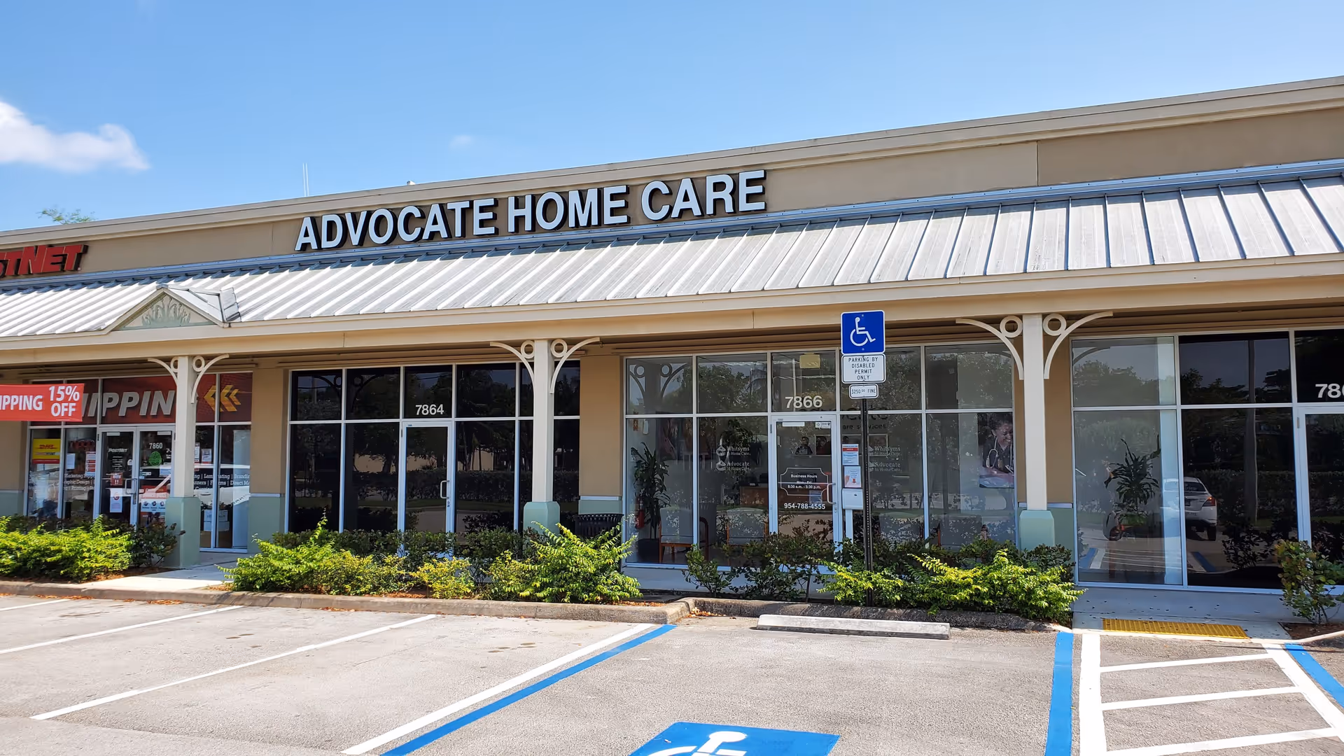 Exterior view of Advocate Home Care storefront with glass windows and parking lot.