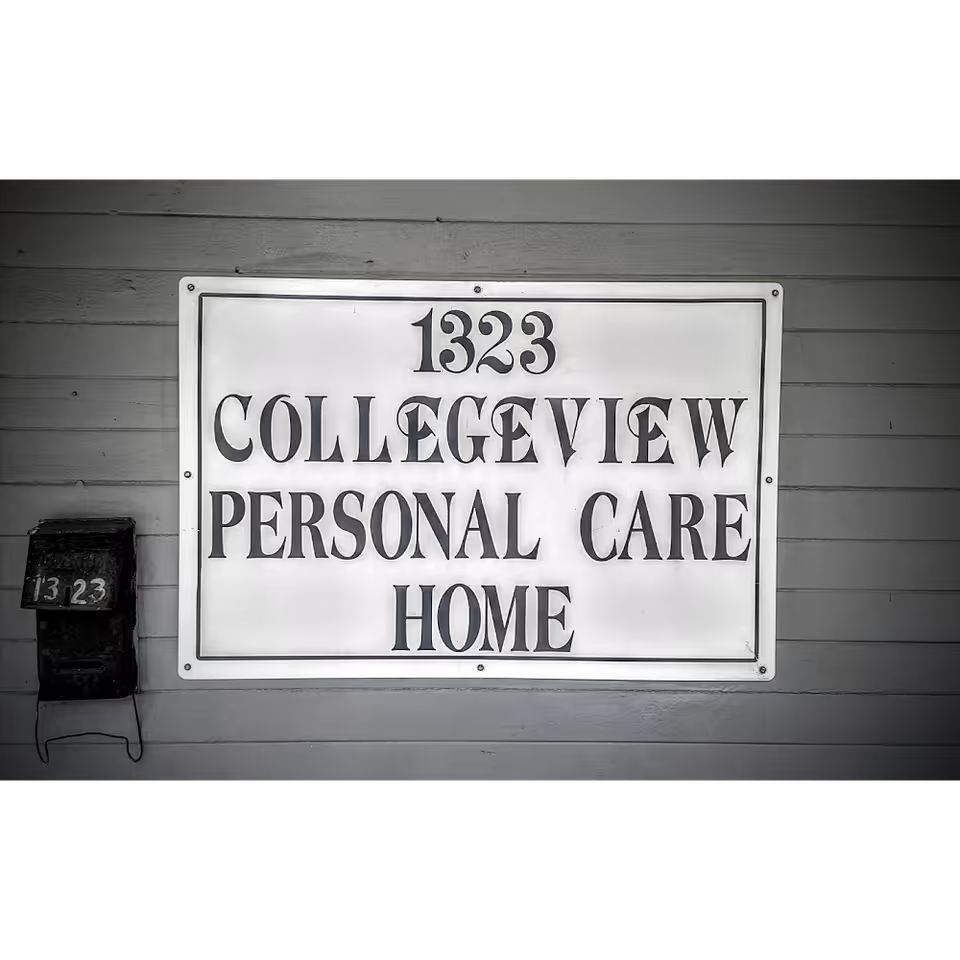 Exterior wall with a large sign reading 1323 Collegeview Personal Care Home and mailbox.