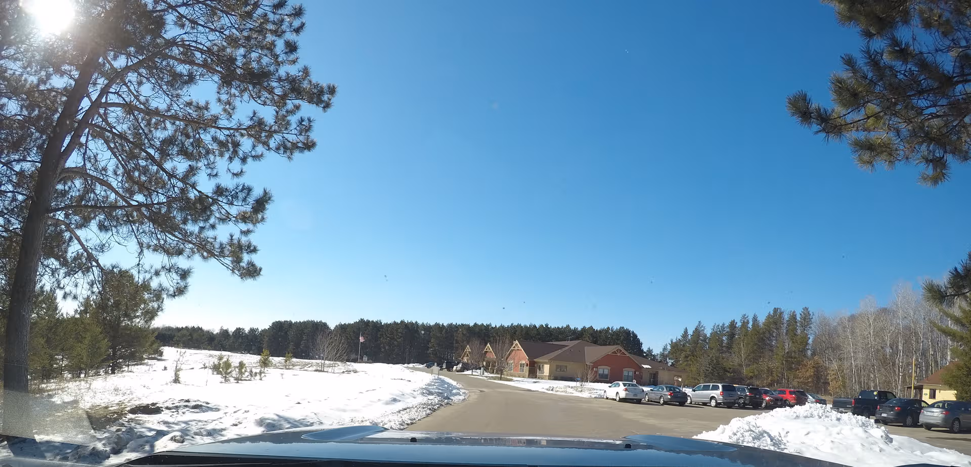Shiloh Assisted Living exterior in snow with parking lot and trees.