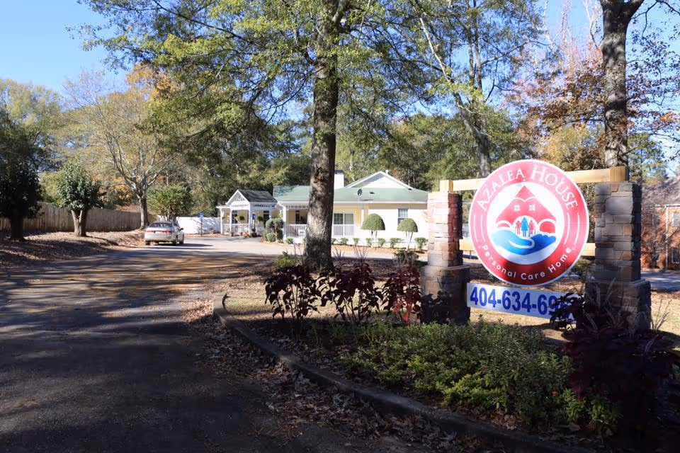 Exterior view of Serenity Empire at Decatur, with entrance, sign, and surrounding trees.