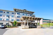 Exterior view of Covenant Village front entrance with a covered drop-off area.