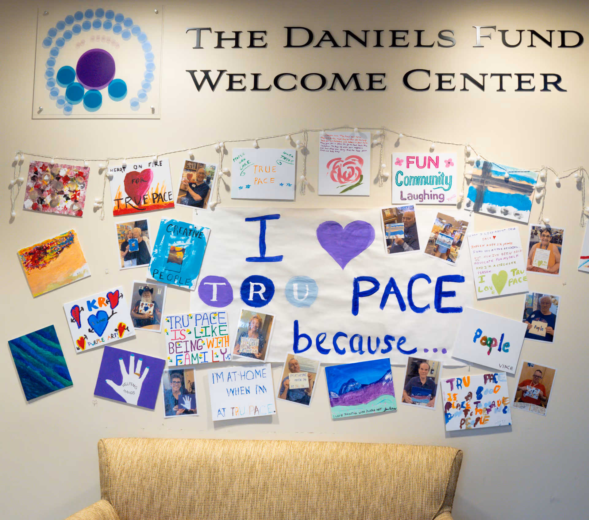 Interior wall at TRU PACE Welcome Center featuring a collage of photos and artwork.