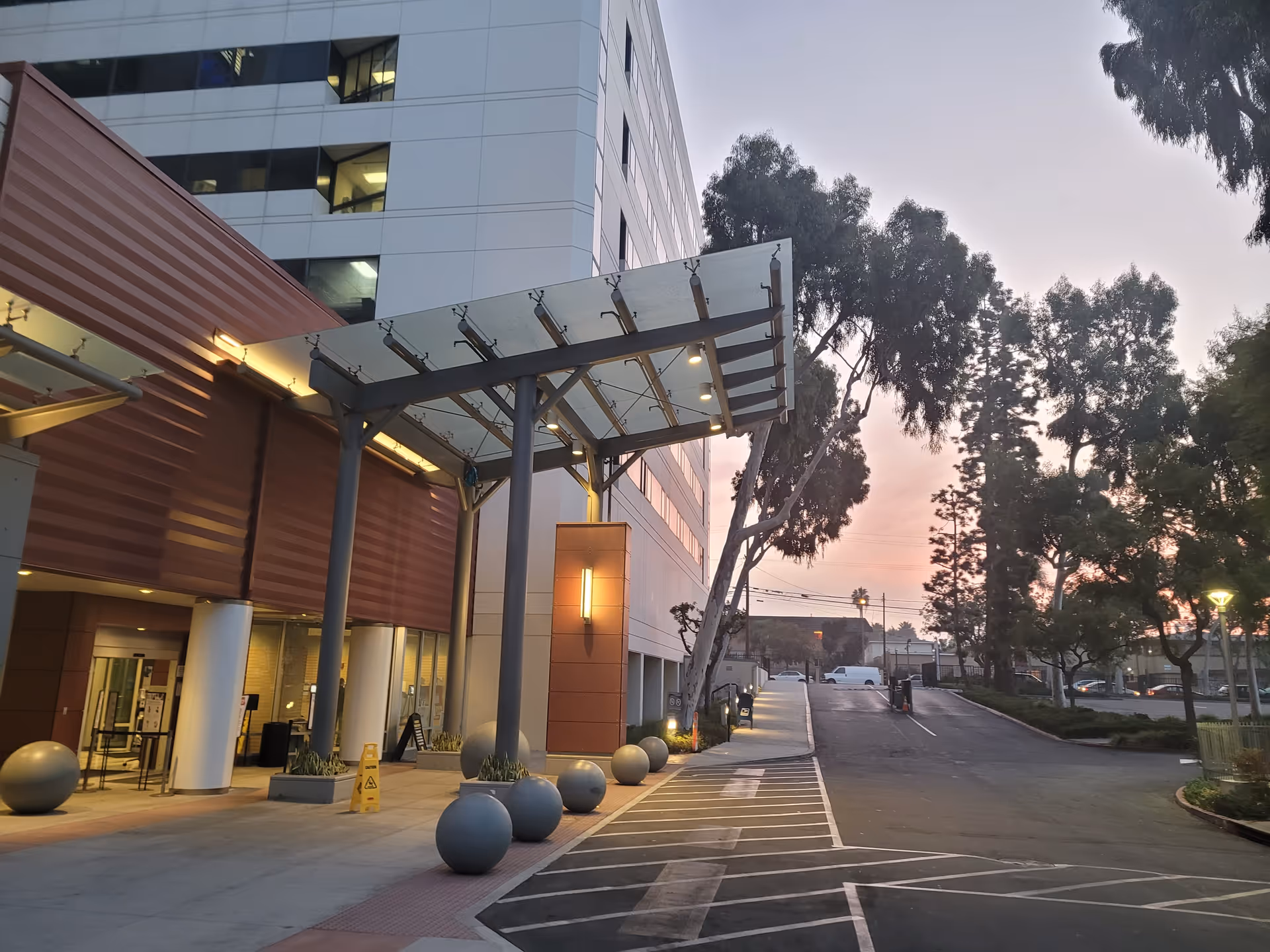 Exterior view of Centinela Hospital Medical Center with a covered entrance at dusk.