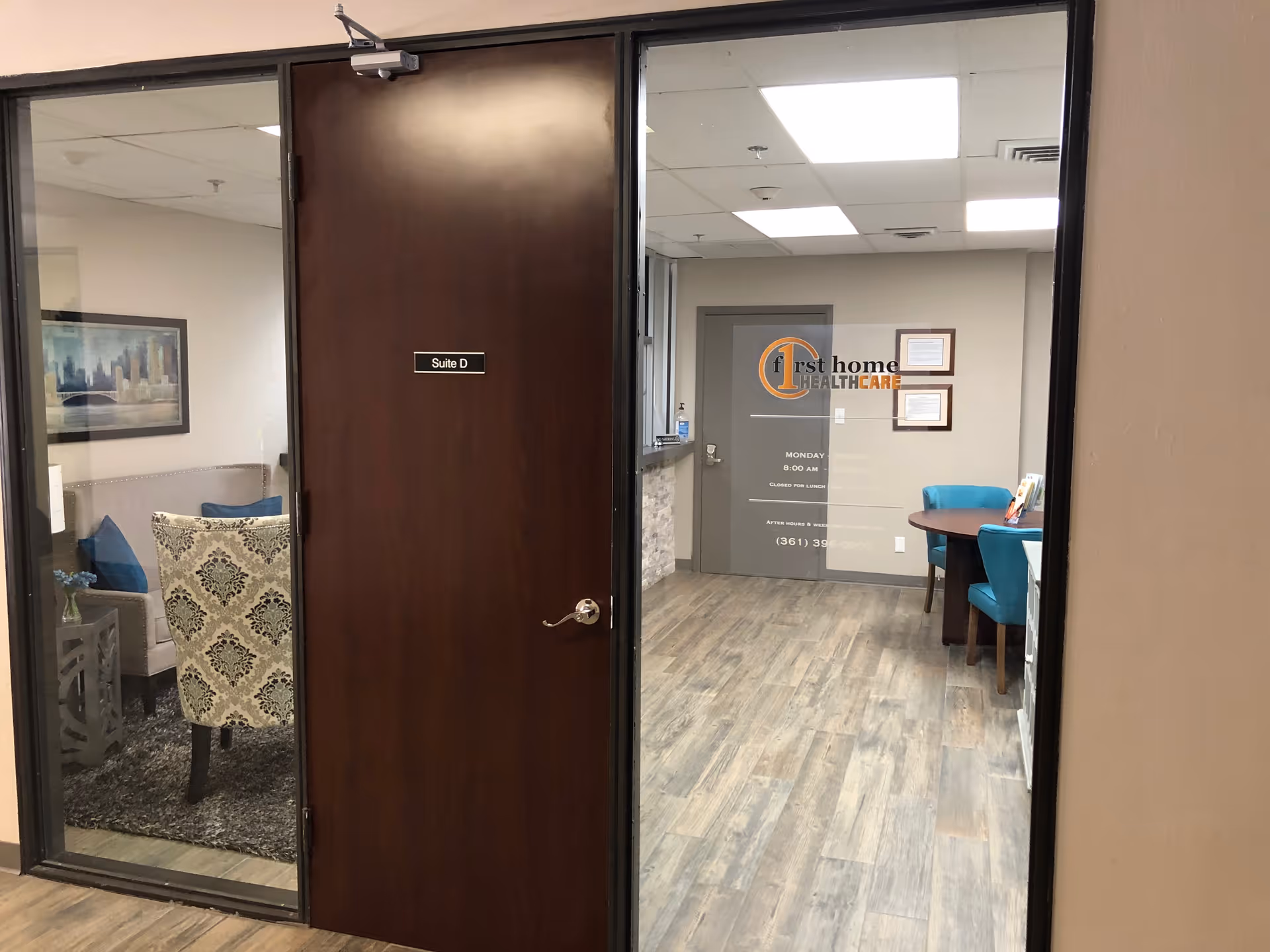 Interior view of a facility hallway with a glass door showing First Home Healthcare signage.