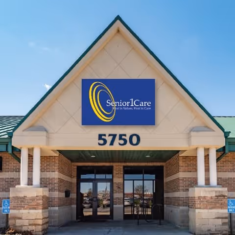 Front exterior of a Senior1Care facility with a brick entrance and large sign.