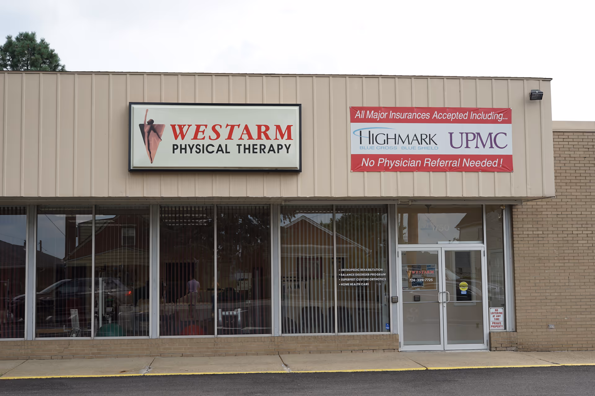 Storefront of WESTARM Physical Therapy with large sign, glass windows, and entrance doors.